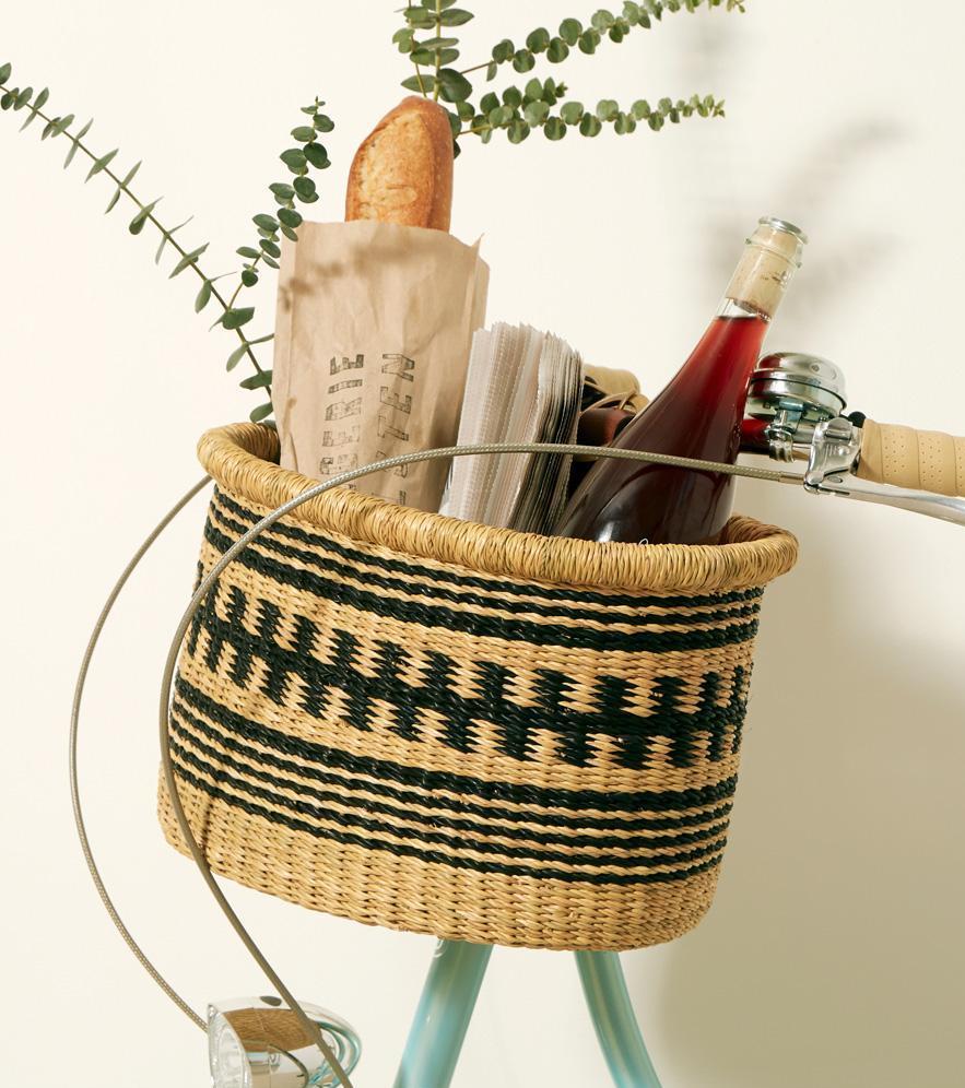Hand woven bike basket. It has 2 adjustable leather straps with brass buckles to secure your basket to the handlebars.